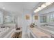 Luxurious main bathroom with a soaking tub, glass shower, and white marble at 5995 Ettington Dr, Suwanee, GA 30024