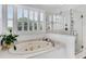 Bright bathroom featuring soaking tub with jets and glass shower with multiple shower heads at 5995 Ettington Dr, Suwanee, GA 30024