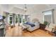 Light-filled main bedroom with vaulted ceiling, hardwood floors, and ample natural light at 5995 Ettington Dr, Suwanee, GA 30024