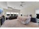 Large bedroom with carpet floors, lots of windows, and a tufted sofa at 5995 Ettington Dr, Suwanee, GA 30024