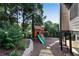 Backyard playground with slide, climbing wall, and swing set at 5995 Ettington Dr, Suwanee, GA 30024
