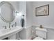 Charming powder room with pedestal sink, nautical decor, and neutral paint at 5995 Ettington Dr, Suwanee, GA 30024