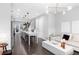 Open concept living room with dark wood floors, modern lighting, and white contemporary furniture at 3933 Danube Ln # 224, Atlanta, GA 30339