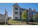 Exterior view of modern townhome featuring brick and siding with manicured landscaping at 1919 Deco Dr, Kennesaw, GA 30144
