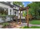 Inviting back deck with wooden pergola, steps, and lush greenery for relaxing and entertaining at 4745 Masters Ct, Duluth, GA 30096