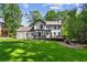 Home with a brick patio, an outdoor fireplace, and lush grass perfect for entertaining at 4745 Masters Ct, Duluth, GA 30096