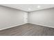 Unfinished basement with gray walls and gray wood-look vinyl flooring offers plenty of room for activities at 4745 Masters Ct, Duluth, GA 30096