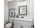 Bathroom featuring modern vanity with white countertop, stylish mirror, and toilet at 4745 Masters Ct, Duluth, GA 30096