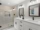 New bathroom with a double sink vanity, quartz countertop, black accents and a glass walk-in shower at 4745 Masters Ct, Duluth, GA 30096