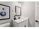 Bathroom featuring modern vanity with white countertop, stylish mirror, and toilet at 4745 Masters Ct, Duluth, GA 30096