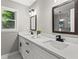 Bathroom with double vanity, two mirrors, quartz countertop, black fixtures and a large window at 4745 Masters Ct, Duluth, GA 30096