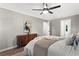 Primary bedroom boasting a ceiling fan, neutral colored walls, accent artwork, and light-colored floors at 4745 Masters Ct, Duluth, GA 30096