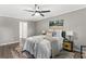 Bedroom with a ceiling fan, neutral colored walls, accent artwork, and light-colored floors at 4745 Masters Ct, Duluth, GA 30096