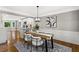 Dining area showcasing modern lighting, hardwood floors, and a view into the stylish kitchen at 4745 Masters Ct, Duluth, GA 30096