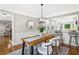 Open-concept dining room with hardwood floors, stylish furniture, and a view into the modern kitchen at 4745 Masters Ct, Duluth, GA 30096