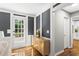 Foyer with dark accent wall, light floors, a door to the outside and into a modern kitchen at 4745 Masters Ct, Duluth, GA 30096