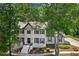 Beautiful two-story home with painted brick, black shutters and mature trees at 4745 Masters Ct, Duluth, GA 30096