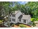 Elegant two-story home with painted brick exterior and black shutters surrounded by mature trees at 4745 Masters Ct, Duluth, GA 30096