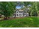 Two story home featuring black trimmed windows, landscaping, and a sprawling front lawn at 4745 Masters Ct, Duluth, GA 30096