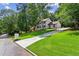 Beautiful home with long driveway, lush green lawn, and mature trees providing privacy and curb appeal at 4745 Masters Ct, Duluth, GA 30096
