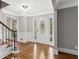 Bright foyer with hardwood floors, staircase, stained glass door, and sophisticated gray walls at 4745 Masters Ct, Duluth, GA 30096