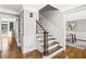 Entryway with wood stairs, dark spindles, and light walls, leading to the upper level at 4745 Masters Ct, Duluth, GA 30096