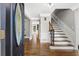 Elegant foyer with hardwood floors, staircase, decorative door, and neutral color palette at 4745 Masters Ct, Duluth, GA 30096