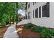 Charming white brick home with black shutters, manicured landscaping, and inviting walkway at 4745 Masters Ct, Duluth, GA 30096