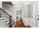 Hallway view featuring hardwood floors, staircase, and architectural details, leading into a bright room at 4745 Masters Ct, Duluth, GA 30096