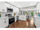 Updated kitchen with white cabinets, stainless steel appliances, and a view into the dining area at 4745 Masters Ct, Duluth, GA 30096