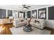 Living room with hardwood floors, built in shelving, fireplace, and lots of natural light at 4745 Masters Ct, Duluth, GA 30096