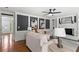 Living room with hardwood floors, built in shelving, fireplace, and lots of natural light at 4745 Masters Ct, Duluth, GA 30096