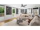 Bright living room with hardwood floors, fireplace, neutral walls, ceiling fan and multiple windows overlooking the yard at 4745 Masters Ct, Duluth, GA 30096