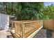 New backyard deck with a natural wooden railing and newly landscaped area at 935 Bobcat Se Ct, Marietta, GA 30067