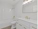 Bright bathroom featuring a tub/shower, white vanity with ample storage, and gold fixtures at 935 Bobcat Se Ct, Marietta, GA 30067