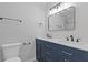 Bathroom with double sink vanity, framed mirror, and modern lighting fixtures at 935 Bobcat Se Ct, Marietta, GA 30067