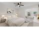Bright bedroom features a ceiling fan and adjacent seating area with ample natural light at 935 Bobcat Se Ct, Marietta, GA 30067