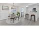 Bright dining room with modern lighting, new floors, and bar seating leading to the kitchen at 935 Bobcat Se Ct, Marietta, GA 30067