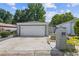 Detached two-car garage with a white door and gray brick exterior, complemented by a spacious driveway at 935 Bobcat Se Ct, Marietta, GA 30067