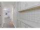 Hallway with tile countertops, wooden cabinets, and a view into other rooms at 935 Bobcat Se Ct, Marietta, GA 30067