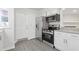A modern kitchen showcasing stainless steel appliances, white cabinetry, and granite countertops at 935 Bobcat Se Ct, Marietta, GA 30067