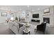 Open-concept living room with a fireplace, and modern furnishings, flowing into the dining area and kitchen at 935 Bobcat Se Ct, Marietta, GA 30067
