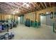 Partially finished basement with exposed ceiling, concrete walls, and paint cans, ready to be customized as you desire at 108 Spring View Br, Dallas, GA 30157