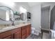 Bright bathroom featuring double sinks, granite countertops, and a decorative shelf at 108 Spring View Br, Dallas, GA 30157