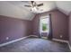 Bedroom with gray carpet, lavender walls, a ceiling fan, a window, and white trim at 108 Spring View Br, Dallas, GA 30157