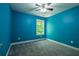 Blue bedroom with carpet flooring, ceiling fan, and bright natural light from window at 108 Spring View Br, Dallas, GA 30157