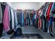 Organized walk-in closet featuring rods, shelves, and ample storage for clothes, hats, and accessories at 108 Spring View Br, Dallas, GA 30157