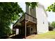 View of the back of the house from the yard with a private deck and walkout basement at 108 Spring View Br, Dallas, GA 30157