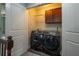 Well-organized laundry room with modern washer and dryer, upper cabinets, and ample space at 108 Spring View Br, Dallas, GA 30157