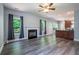 Open living room featuring a fireplace, large windows, stylish flooring, and an open concept design at 108 Spring View Br, Dallas, GA 30157
